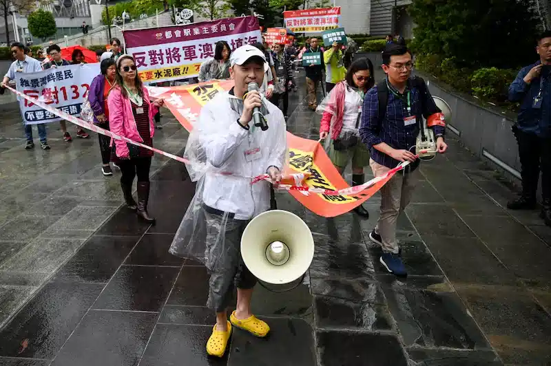 Amid strict rules, Hong Kong residents hold their first protest in years.