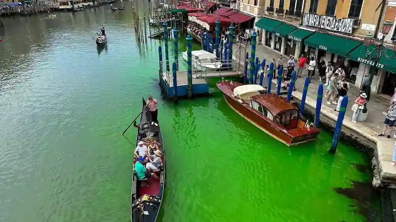 Venice officials probe as canal changes to vibrant green hue.