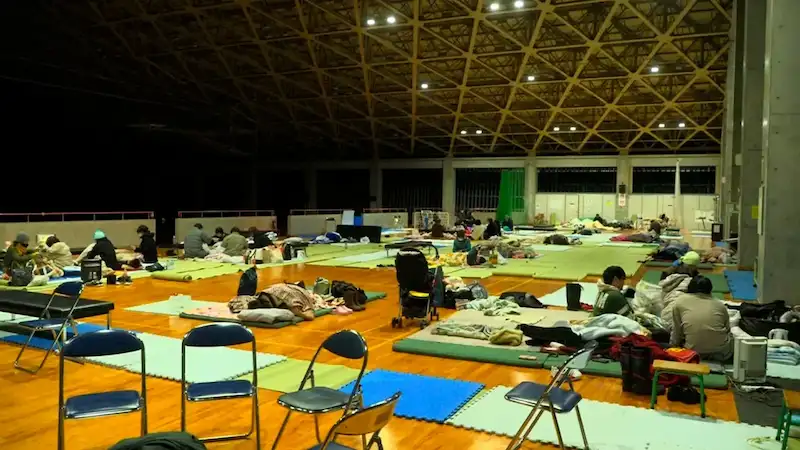 Japanese earthquake survivors brave freezing conditions in shelters without basic amenities.