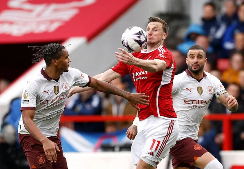 Manchester City maintain title chase with 2-0 victory over Forest.