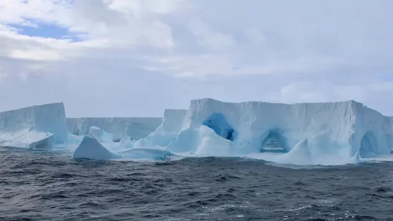 Enormous iceberg caught in an endless dance with swirling ocean currents